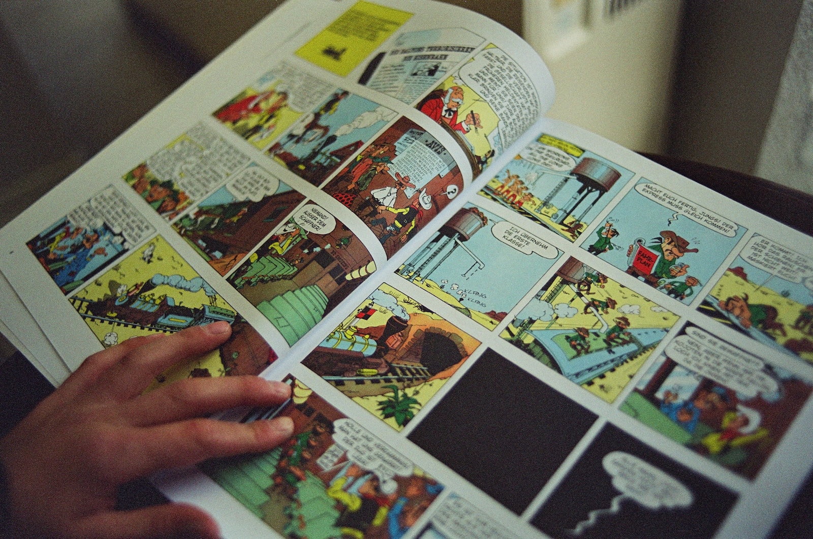 person holding white and black magazine